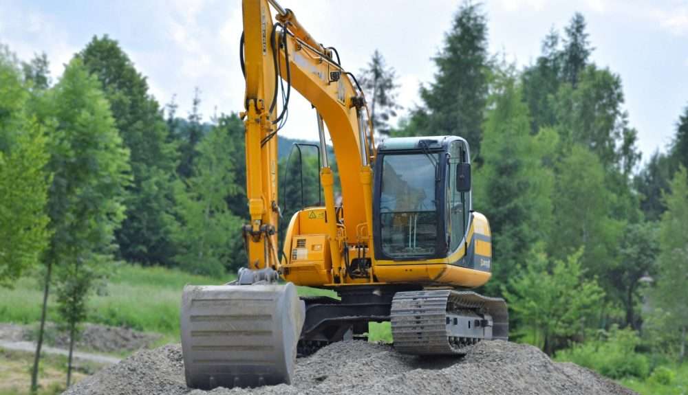 a large industrial digger excavating earth at a mining site.