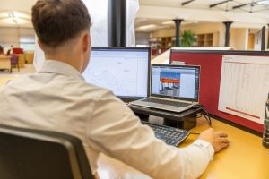 Engineering consultant analysing design plans while using Coretime to improve project management, resource planning and productivity.