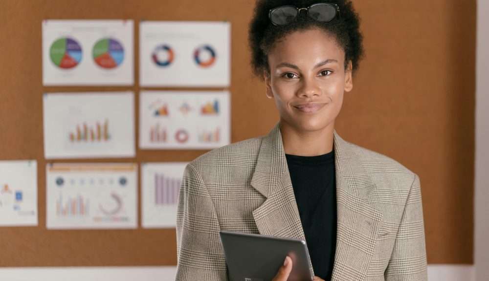 Woman standing in front of lots of project management charts on a wall