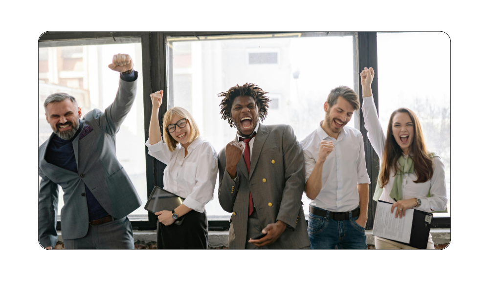 Corporate team of professionals celebrating success with hands raised, representing collaboration, teamwork, and positive workplace culture.